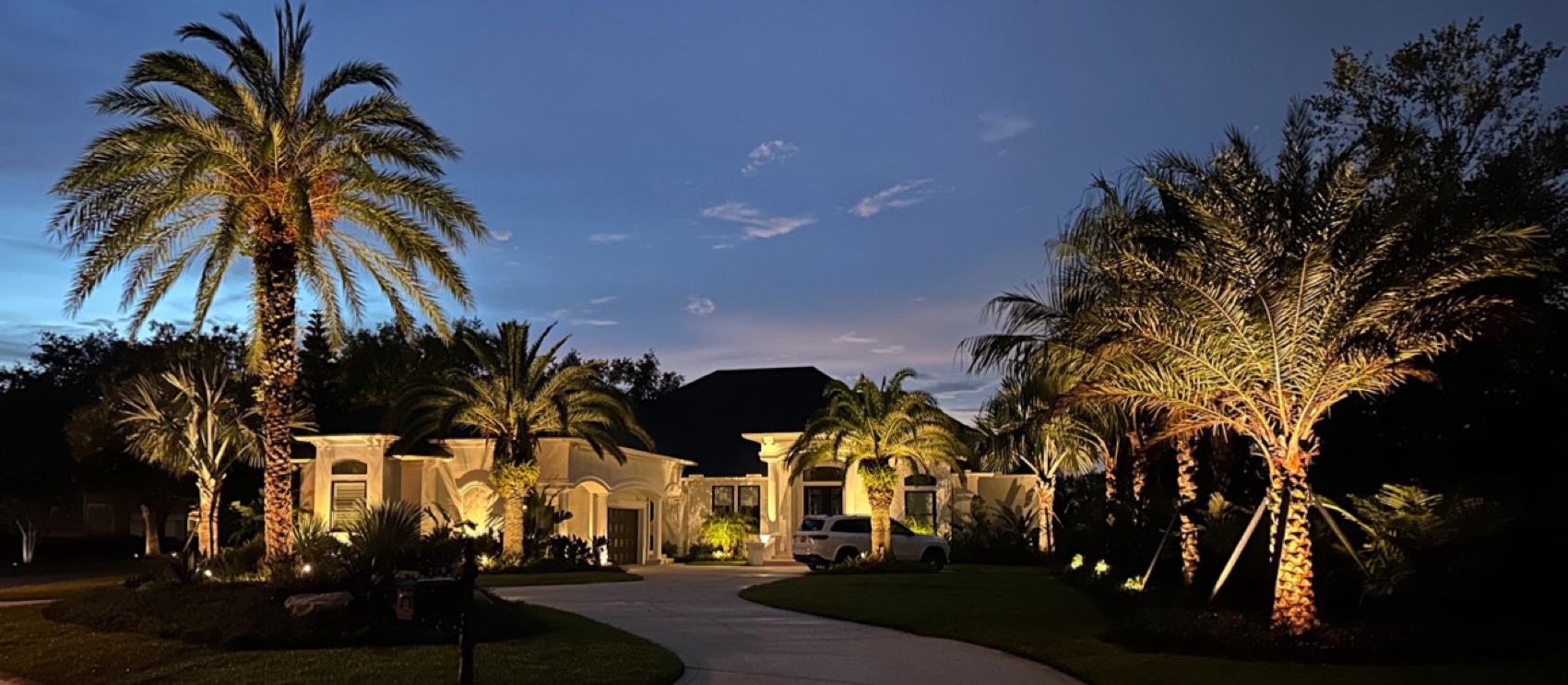 Estate at dusk with landscape lighting
